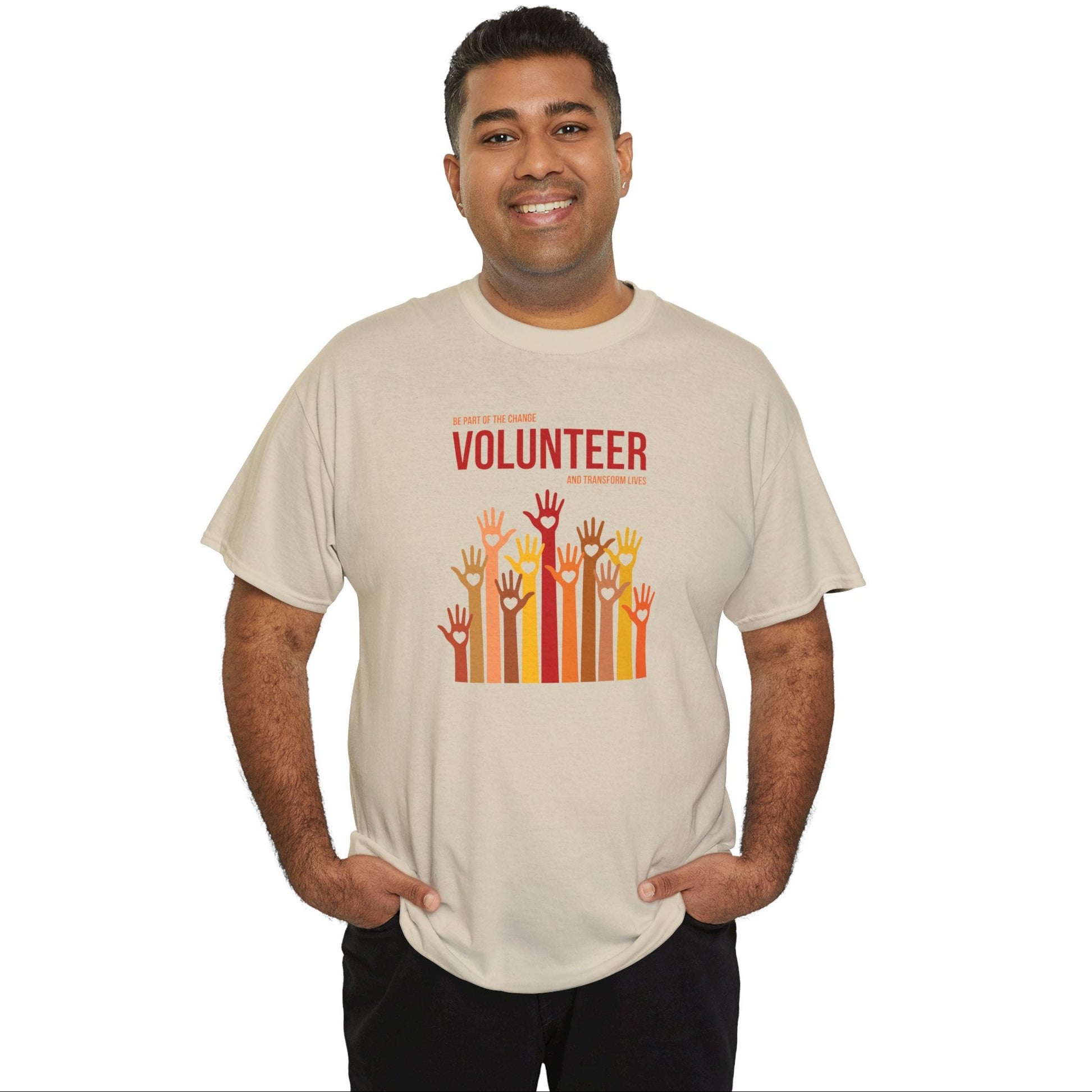 Man wearing a beige t-shirt with 'Volunteer' and raised hands graphic on a white background