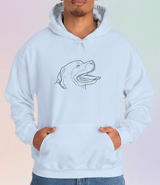 Person wearing a light blue hoodie with a dog design on a pastel background