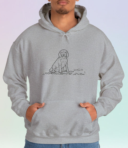 Person wearing a gray hoodie with a dog graphic on a pastel background