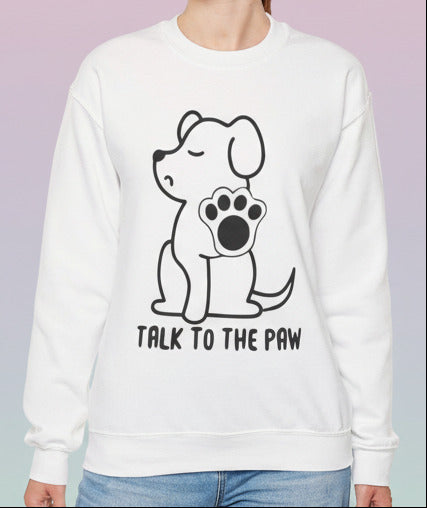 Person wearing a white sweatshirt with a dog graphic and text on a pastel background