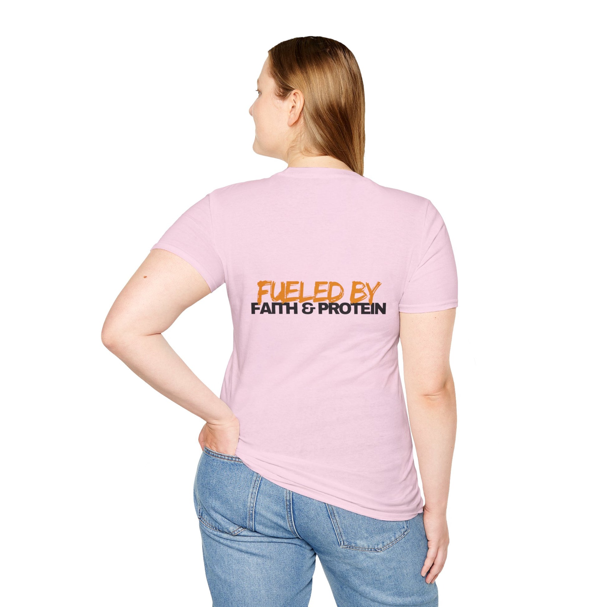 Person wearing a pink t-shirt with 'Fueled by Faith & Protein' text on a white background