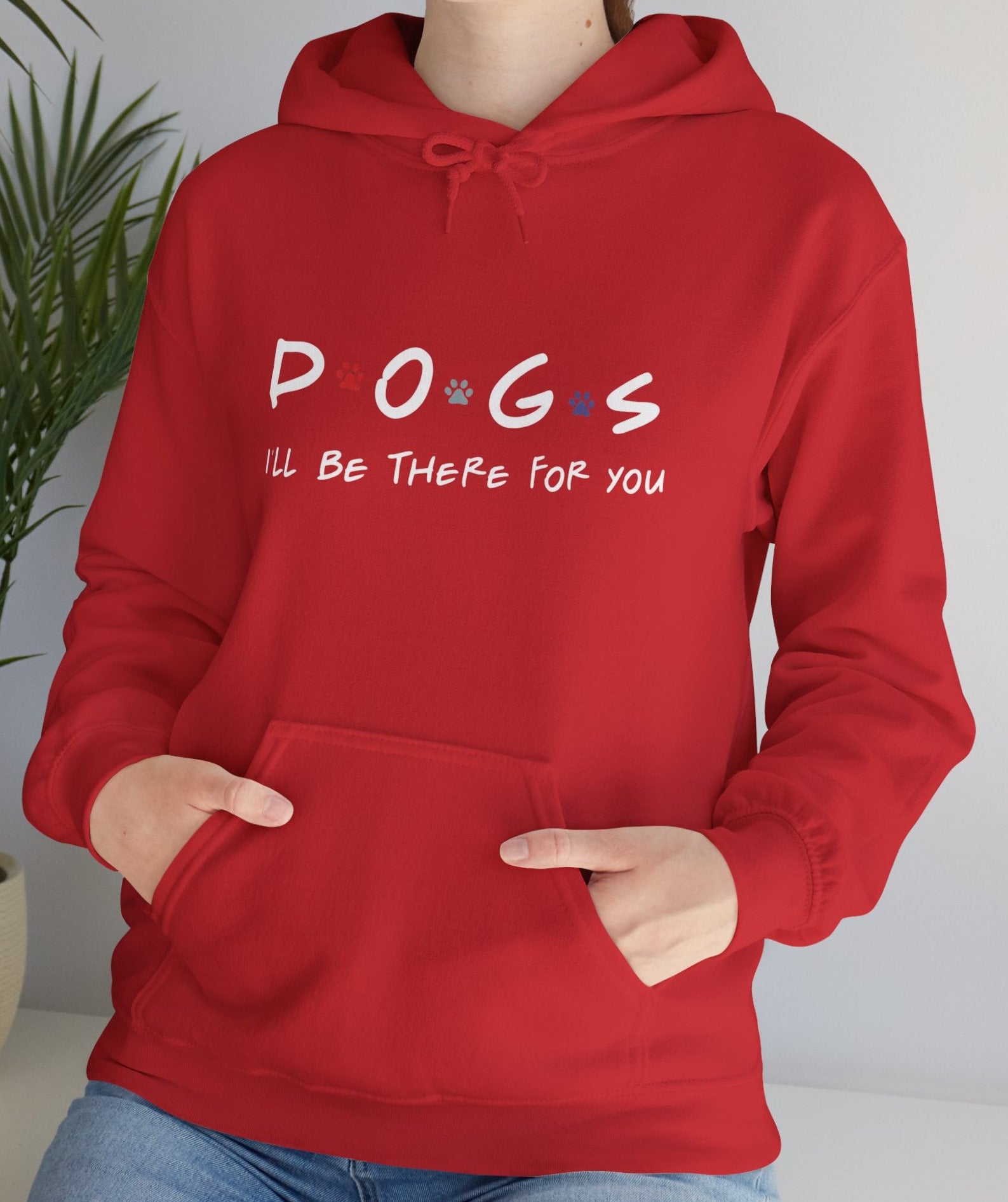 Person wearing a red hoodie with 'DOGS i'll be there for you' text, standing indoors.