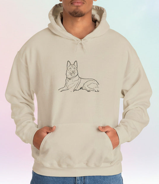 Person wearing a beige hoodie with a dog illustration on a pastel background