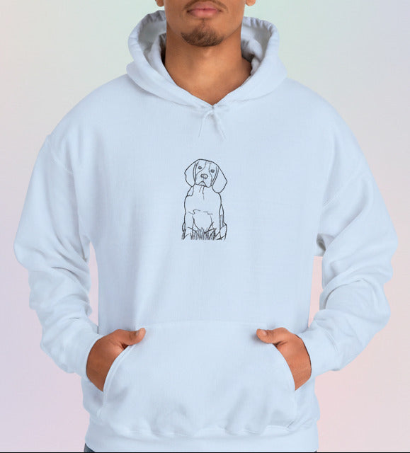 A baby blue hoodie with a dog illustration worn by a man on a pastel background