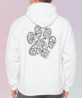 Person wearing a white hoodie with a black paw paisley design on the back against a pastel background