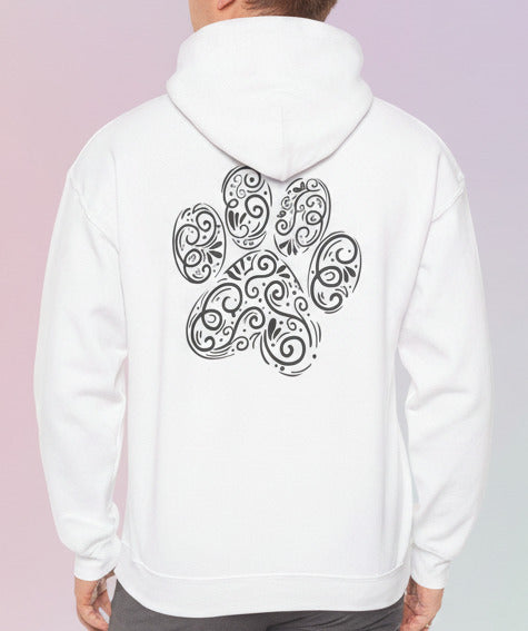 Person wearing a white hoodie with a black paw paisley design on the back against a pastel background