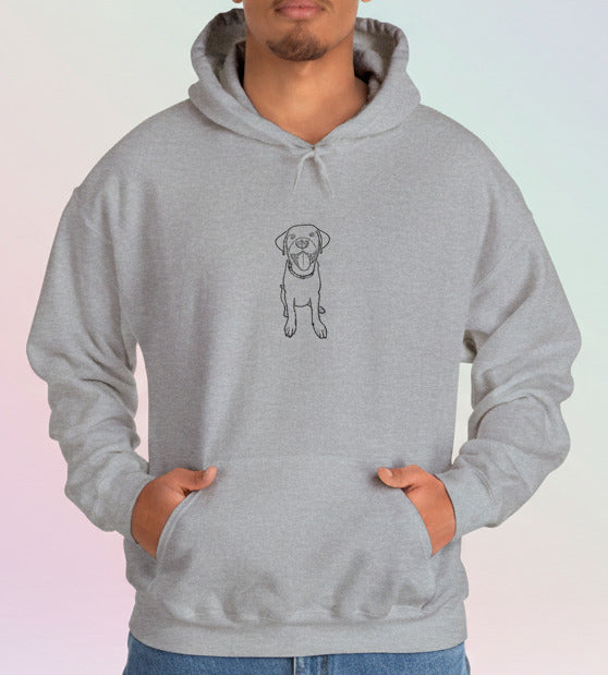 Person wearing a gray hoodie with a dog illustration on a pastel background
