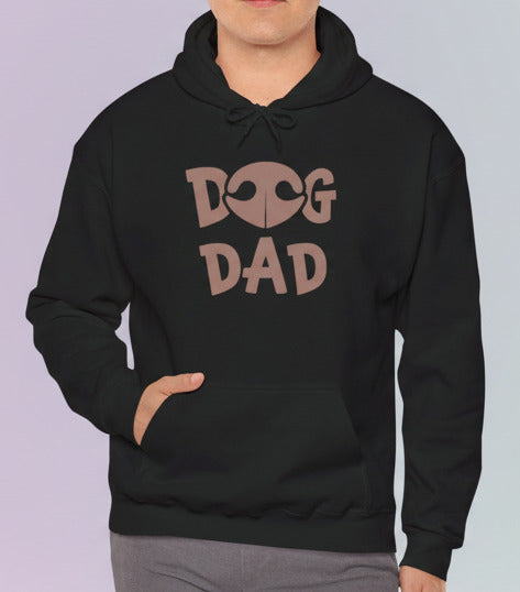 Man wearing a black hoodie with 'DOG DAD' text on a pastel background