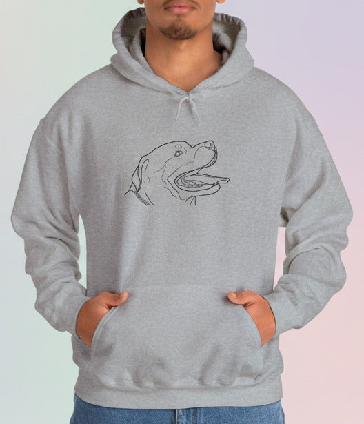 Person wearing a gray hoodie with a dog graphic on a pastel background