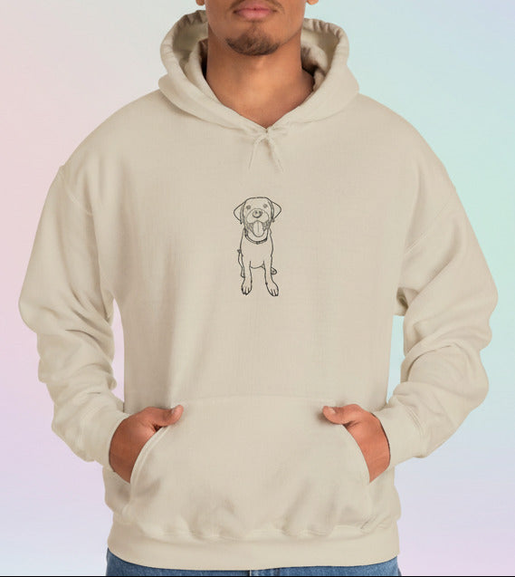 Person wearing a beige hoodie with a dog illustration on a pastel background