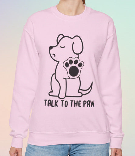 Person wearing a pink sweatshirt with a dog graphic and text on a pastel background