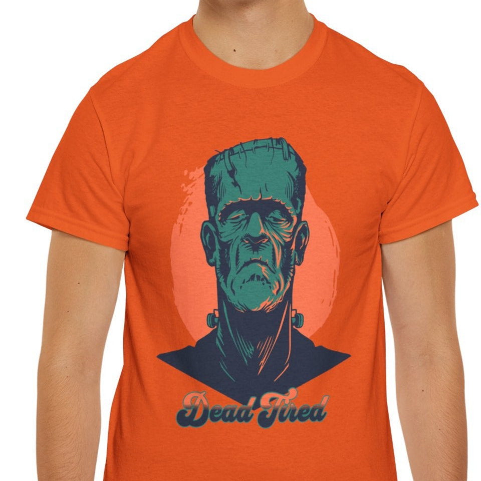Person wearing an orange t-shirt with a graphic design on a white background