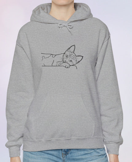 Person wearing a gray hoodie with a cat design on a paste background