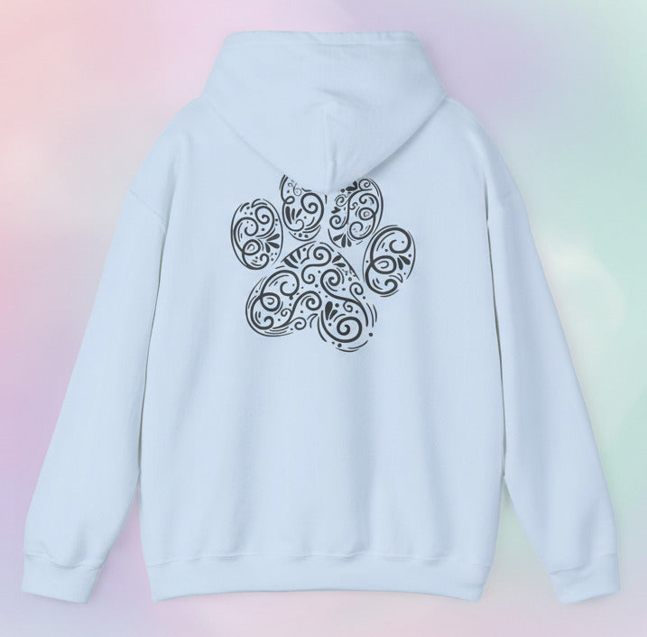 Light blue hoodie with a decorative paw print design on the back against a pastel background