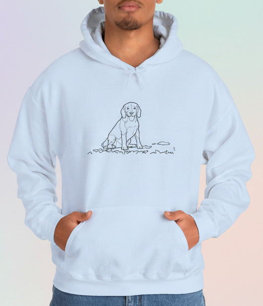 Person wearing a light blue hoodie with a dog graphic on a pastel background