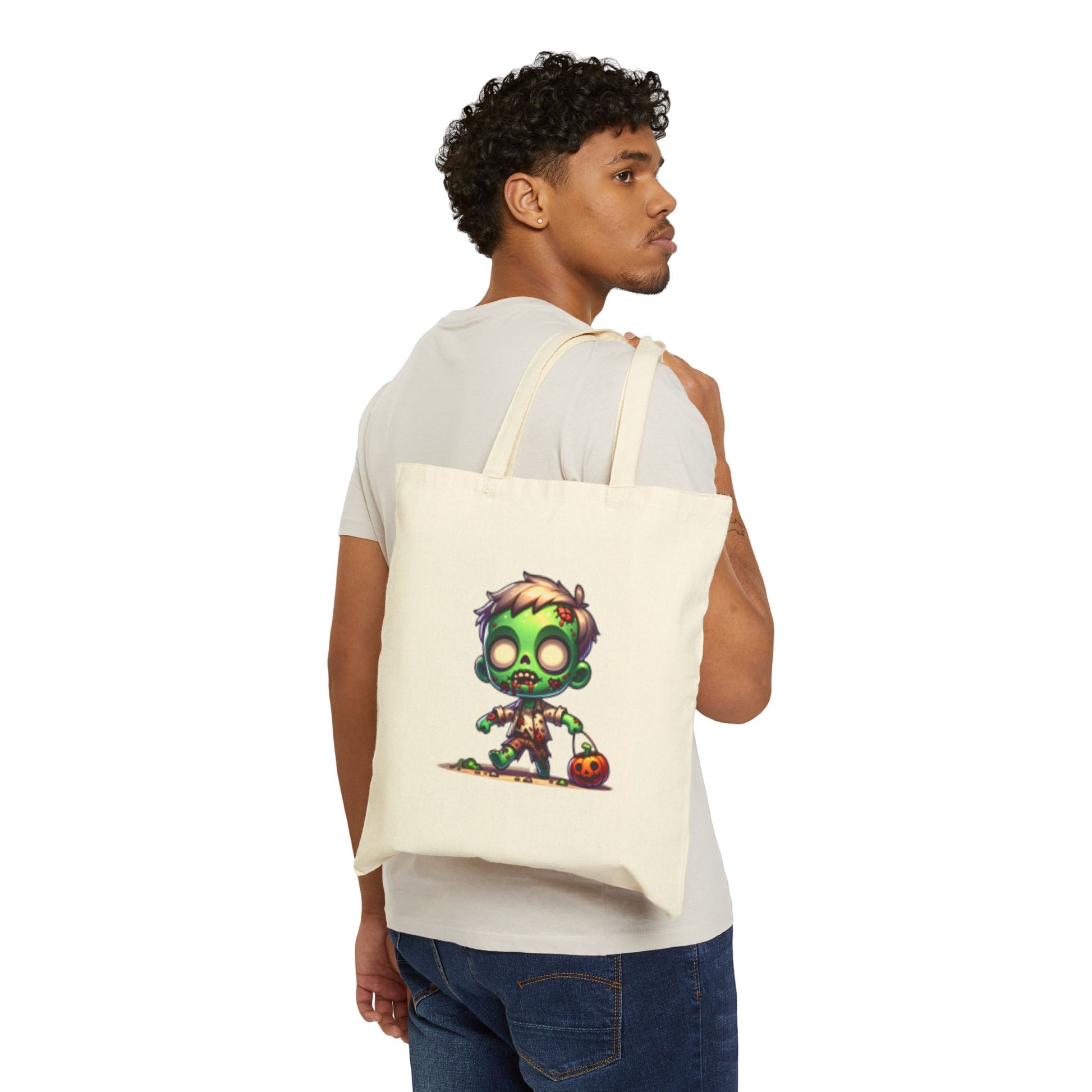 Person holding a tote bag with a colorful zombie design on a white background