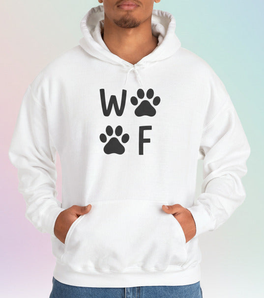Person wearing a white hoodie with 'WOOF' and paw prints on a pastel background