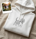 White hoodie with dog illustration and inset photo of a beagle on a beige surface