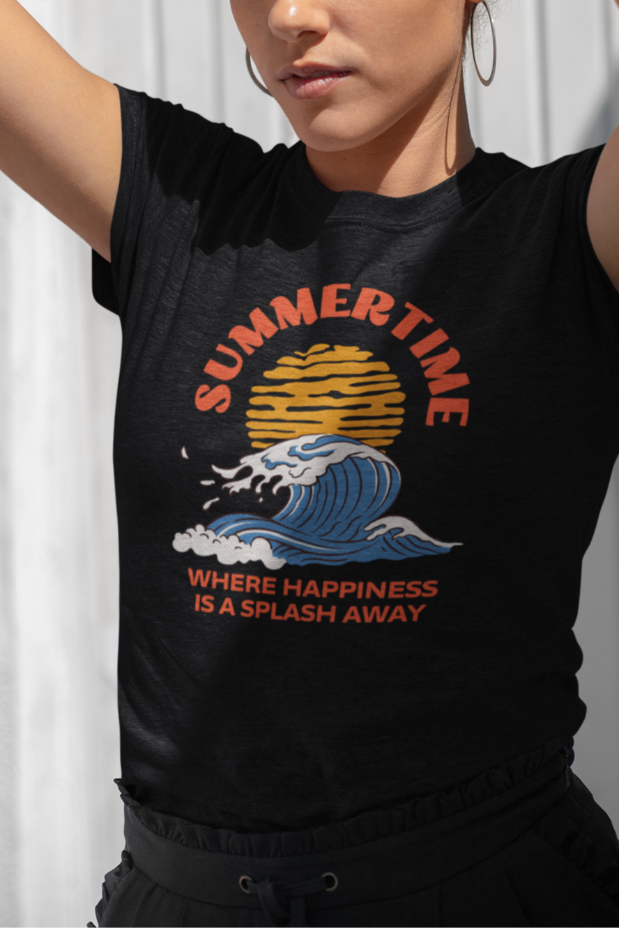 Woman wearing a black t-shirt with a graphic design and text, standing against a white wall.